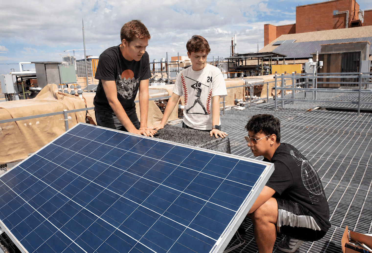 Students learning to install a solar panel